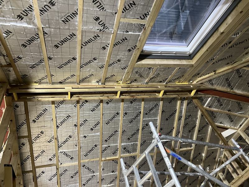 Roof insulation fitted around a rooflight