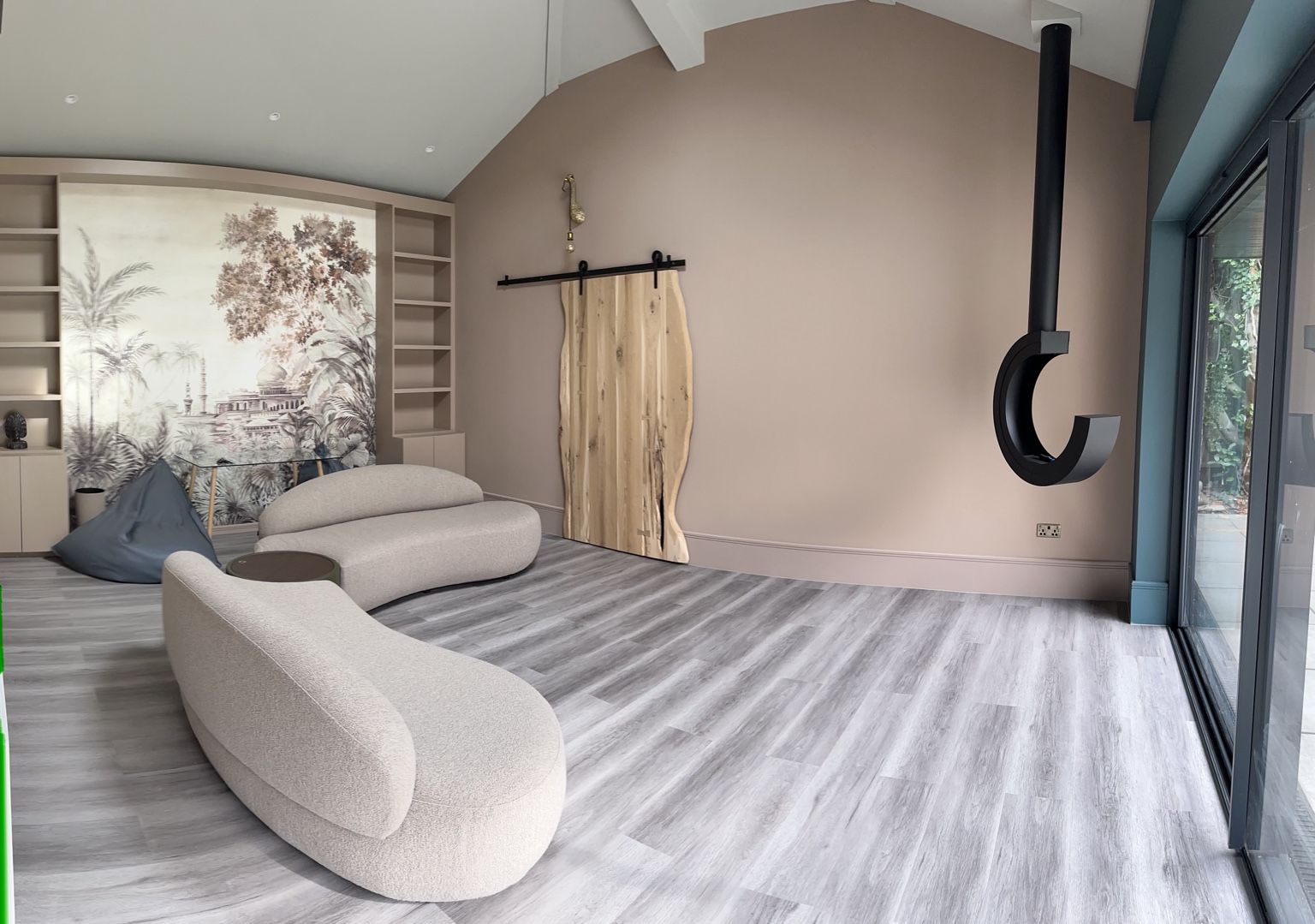 Finished living space with vaulted ceiling, fitted shelving and sliding doors
